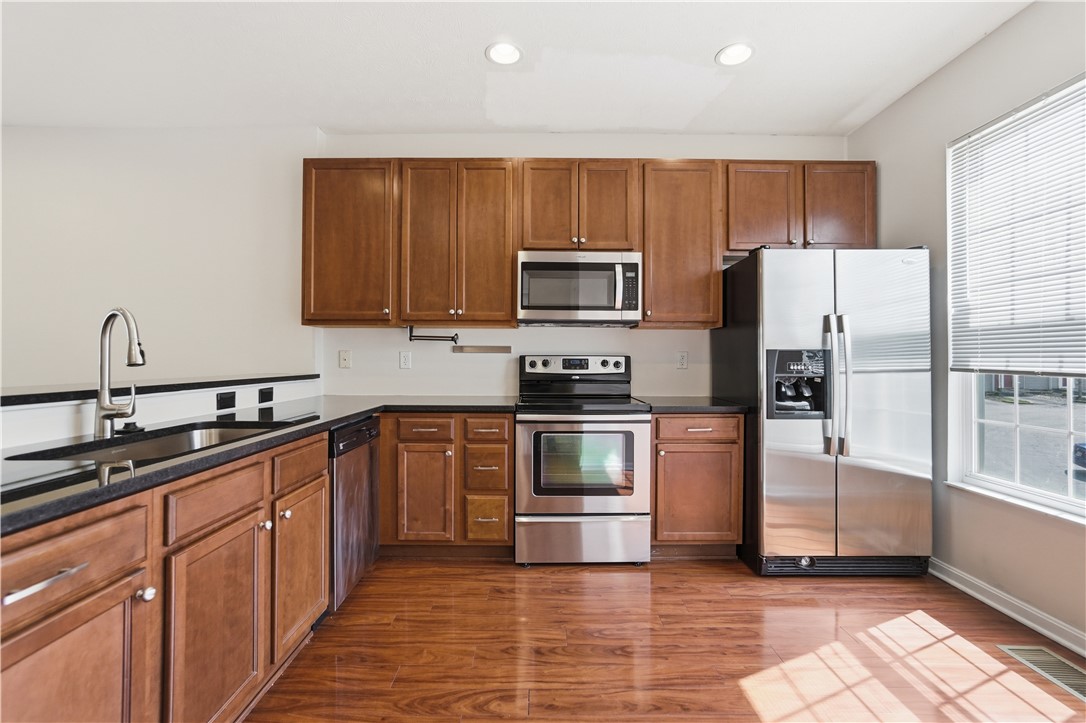 4294 Straight Arrow Road Dayton, OH 45430 - Photo 13 of 41 This modern kitchen features rich wood cabinetry and gleaming stainless steel appliances.