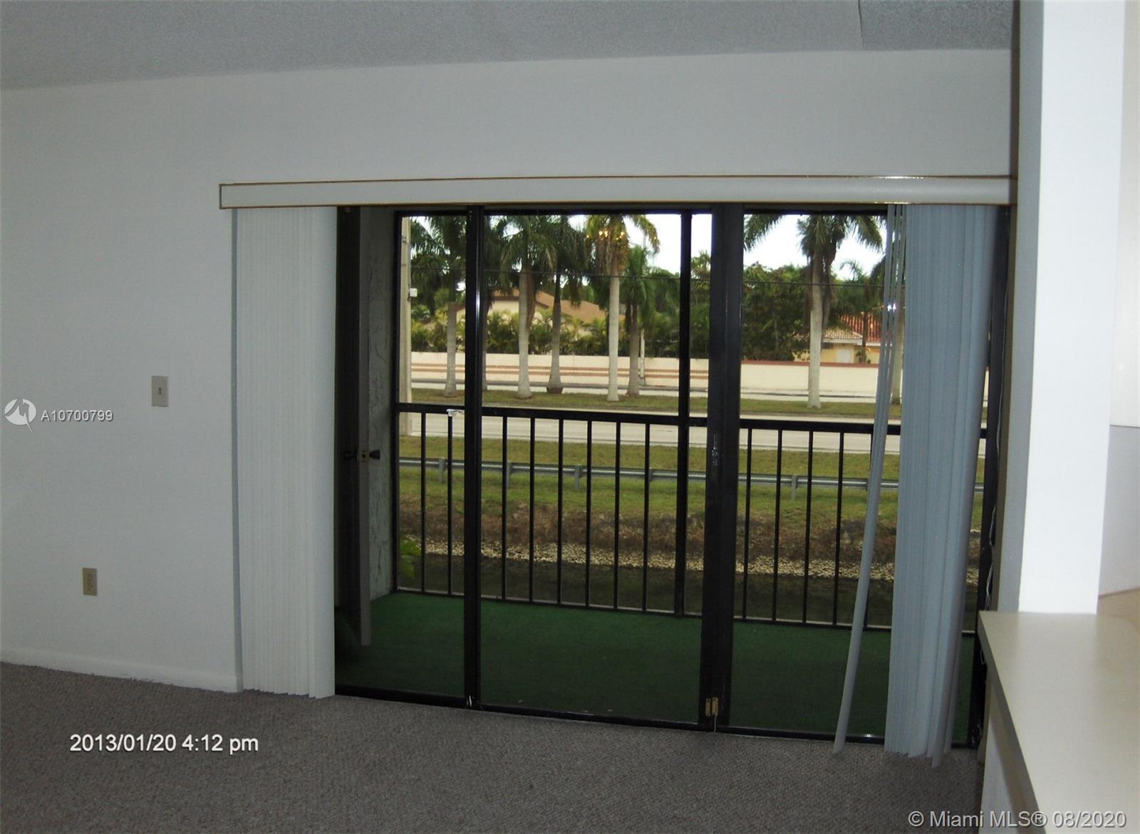 9727 Southwest 138th Avenue, Unit IC2L Miami, FL 33186 - Photo 32 of 44 Sliding Glass Doors to Screened Patio & Wide Canal View