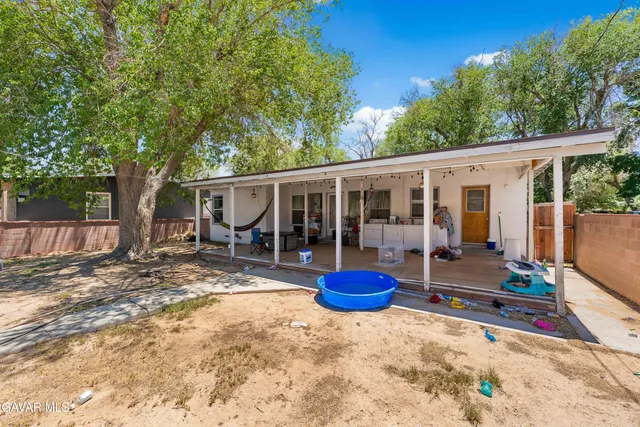 a view of a house with a backyard and porch
