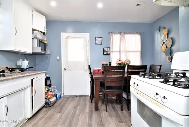 a kitchen with a stove a sink and a refrigerator