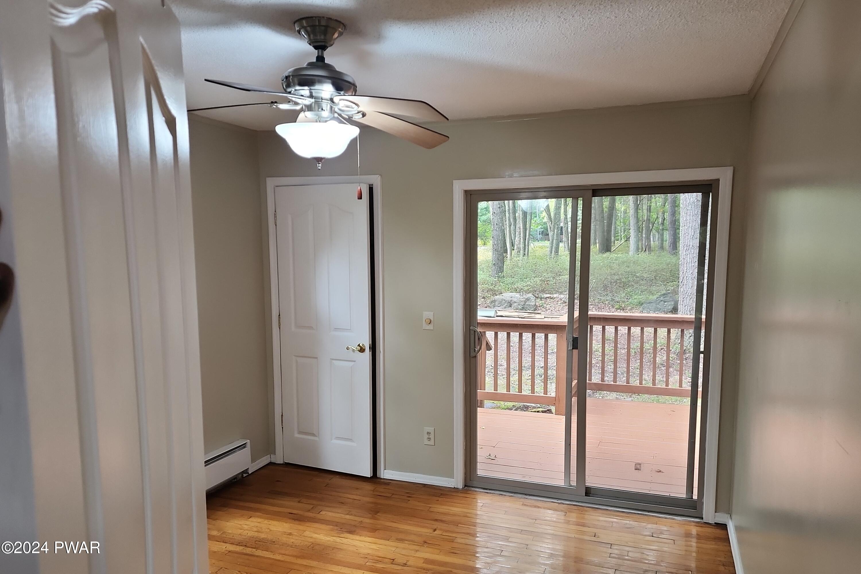 107 Rodeo Lane Hawley, PA 18428 - Photo 17 of 29 a view of an empty room with wooden floor and fan