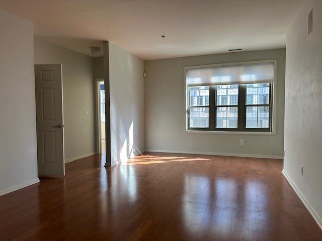 26 Ave At Port Imperial, Unit 210 West New York, NJ 07093 - Photo 3 of 10 a view of an empty room with wooden floor and a window