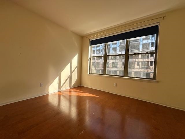 26 Ave At Port Imperial, Unit 210 West New York, NJ 07093 - Photo 4 of 10 a view of an empty room with a window and wooden floor