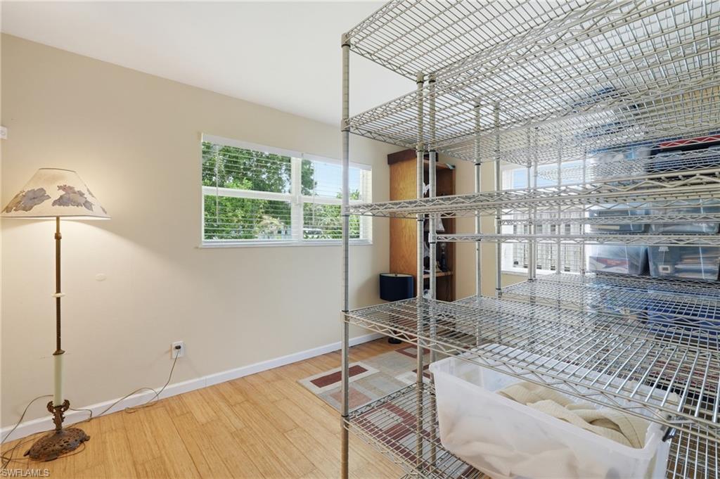 1316 Rordon Avenue Naples, FL 34103 - Photo 27 of 38 Room featuring wood-finish flooring and a multi-panel window with horizontal blinds