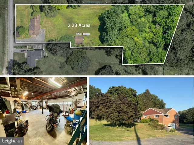 an aerial view of a house with a yard and mountain view