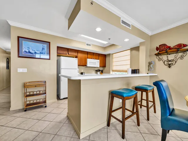 a kitchen with stainless steel appliances a refrigerator and a stove top oven