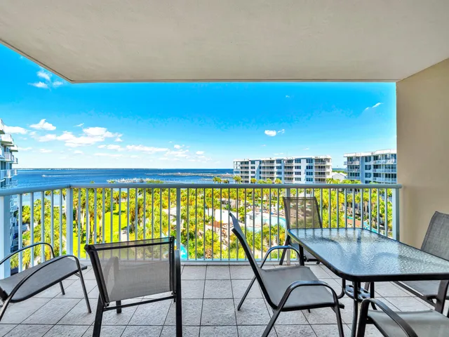 a view of a chairs and table in a balcony