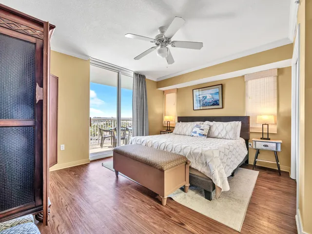 a spacious bedroom with a large bed and a chandelier