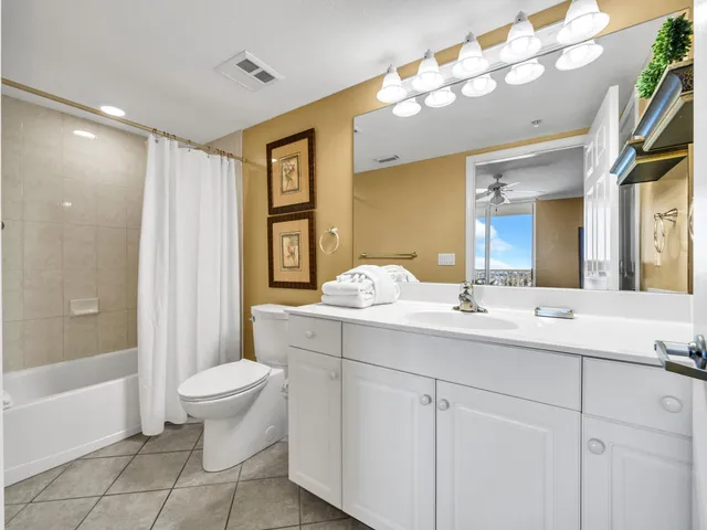 a bathroom with a double vanity sink mirror and toilet