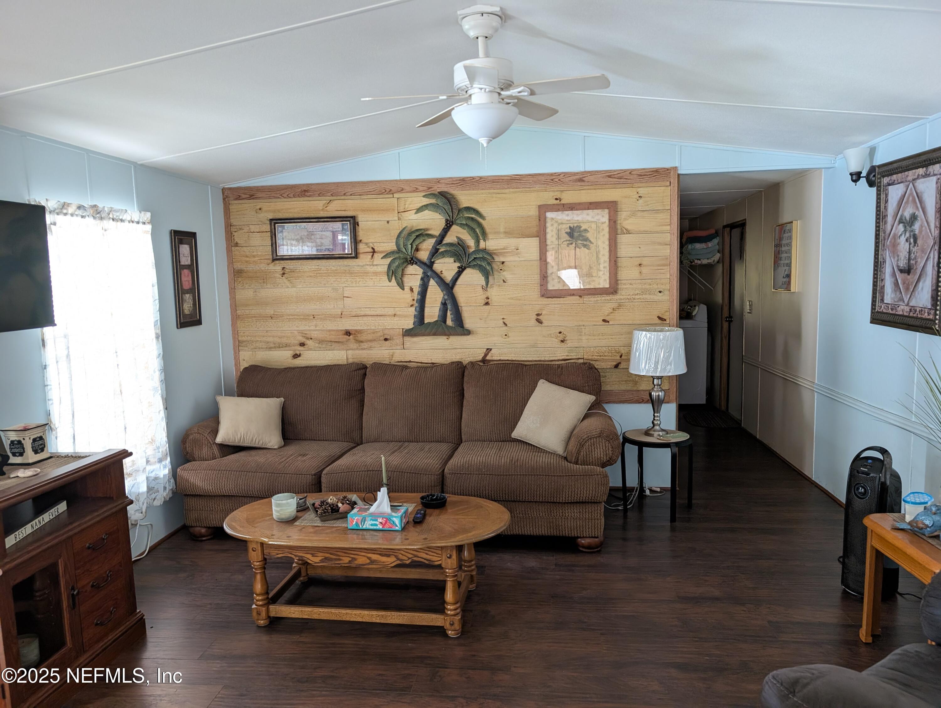 114 Ash Street Interlachen, FL 32148 - Photo 13 of 22 a living room with furniture a table and wooden floor