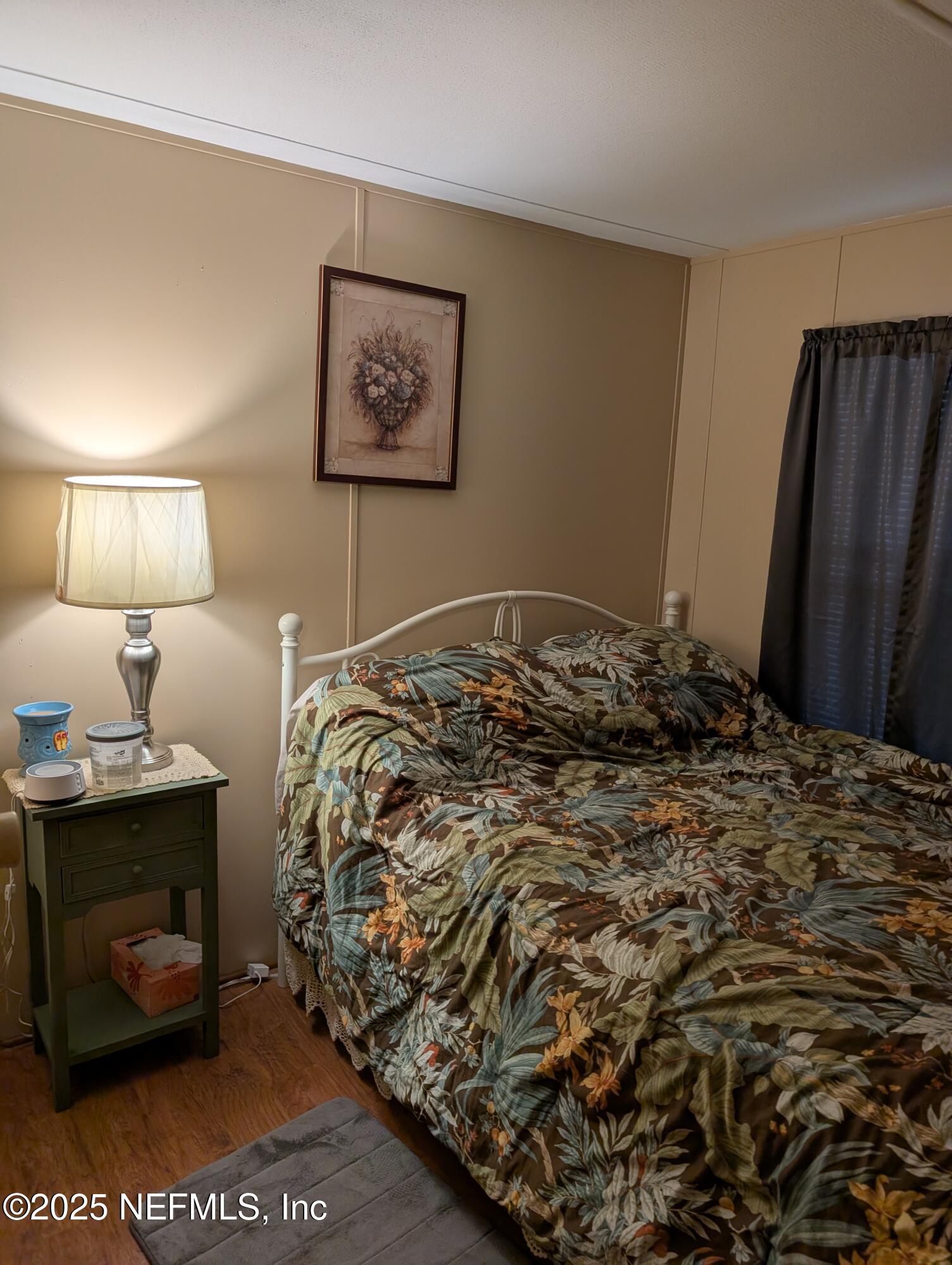 114 Ash Street Interlachen, FL 32148 - Photo 18 of 22 a bedroom with a bed and a lamp on dresser