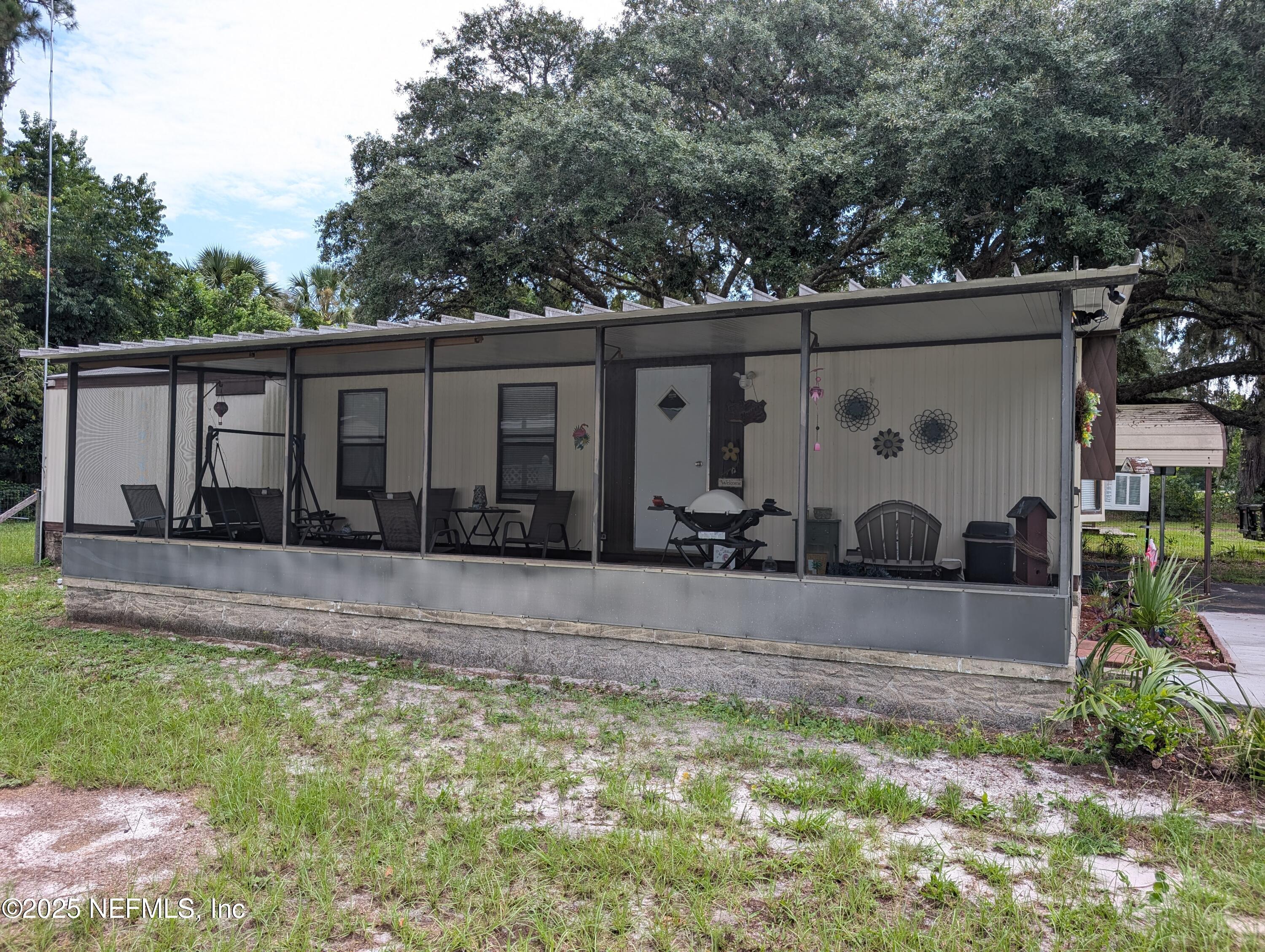114 Ash Street Interlachen, FL 32148 - Photo 2 of 22 front view of house with a yard