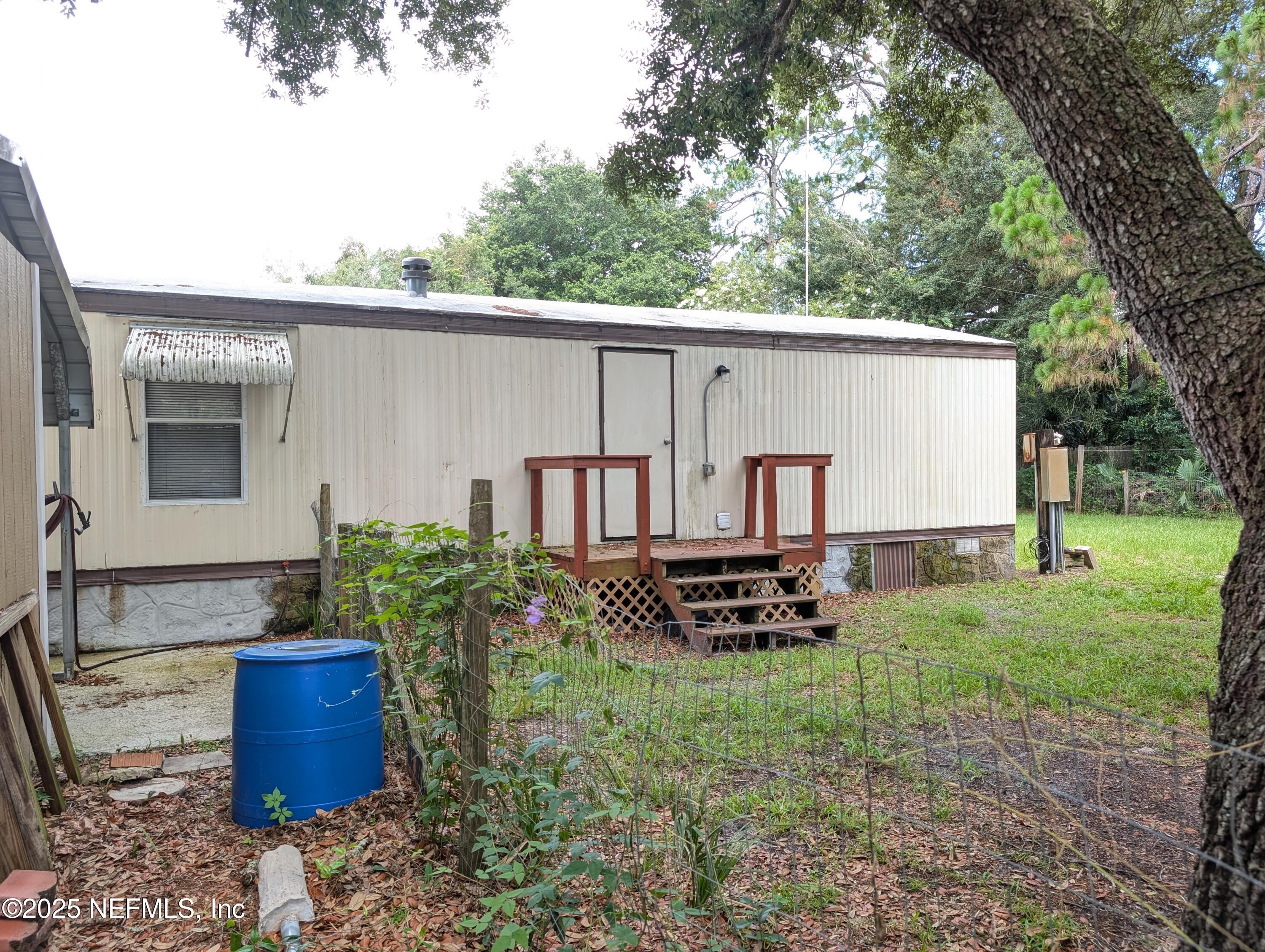 114 Ash Street Interlachen, FL 32148 - Photo 22 of 22 a backyard of a house with barbeque oven fire pit table and chairs
