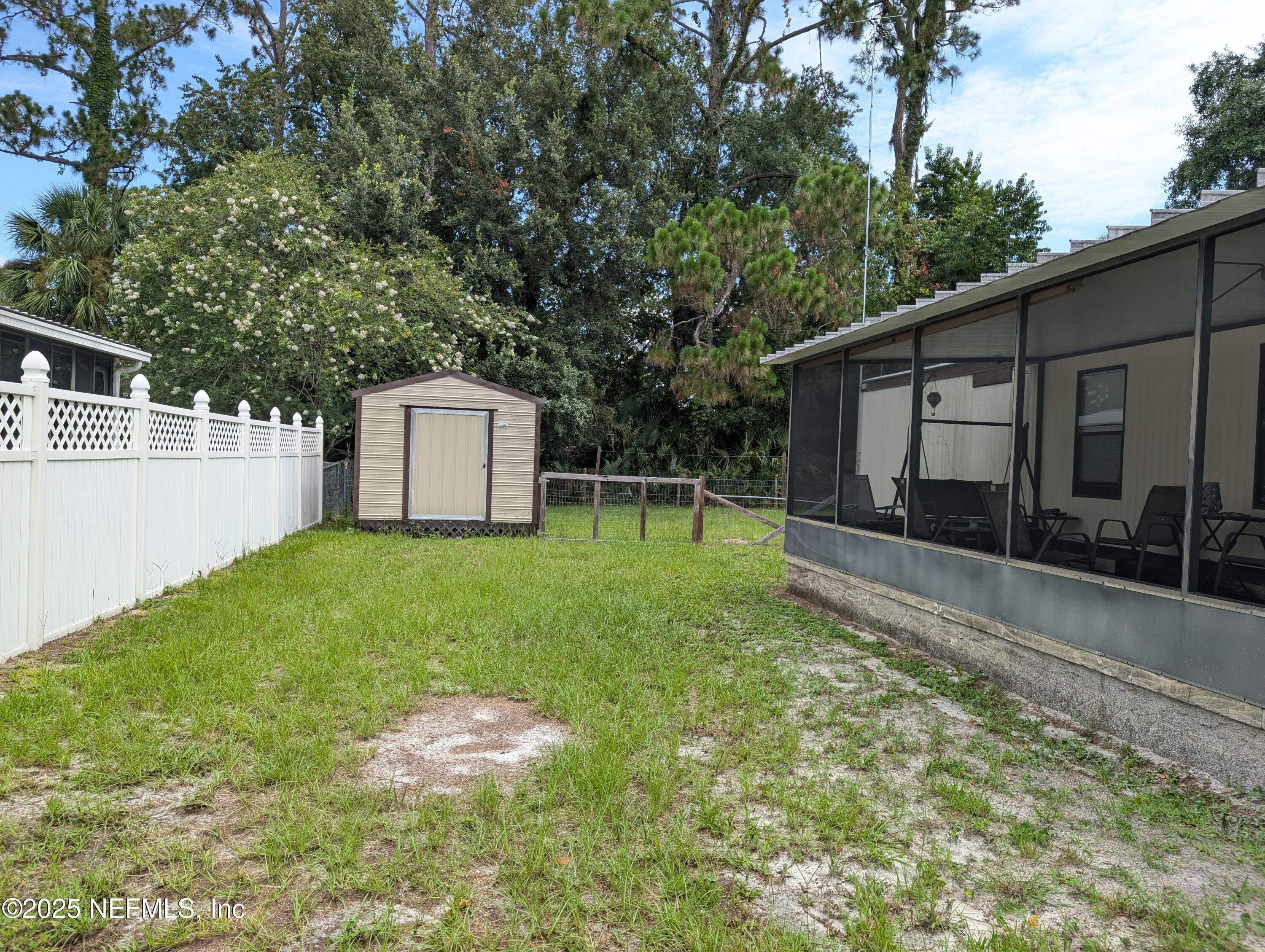 114 Ash Street Interlachen, FL 32148 - Photo 3 of 22 a backyard of a house with table and chairs