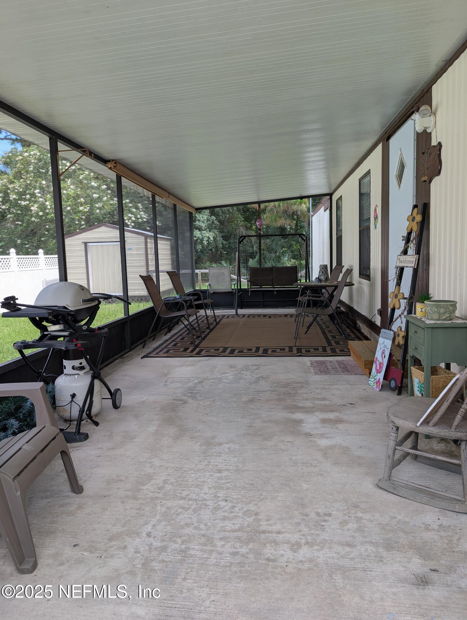 114 Ash Street Interlachen, FL 32148 - Photo 4 of 22 a room with gym equipment and a large window