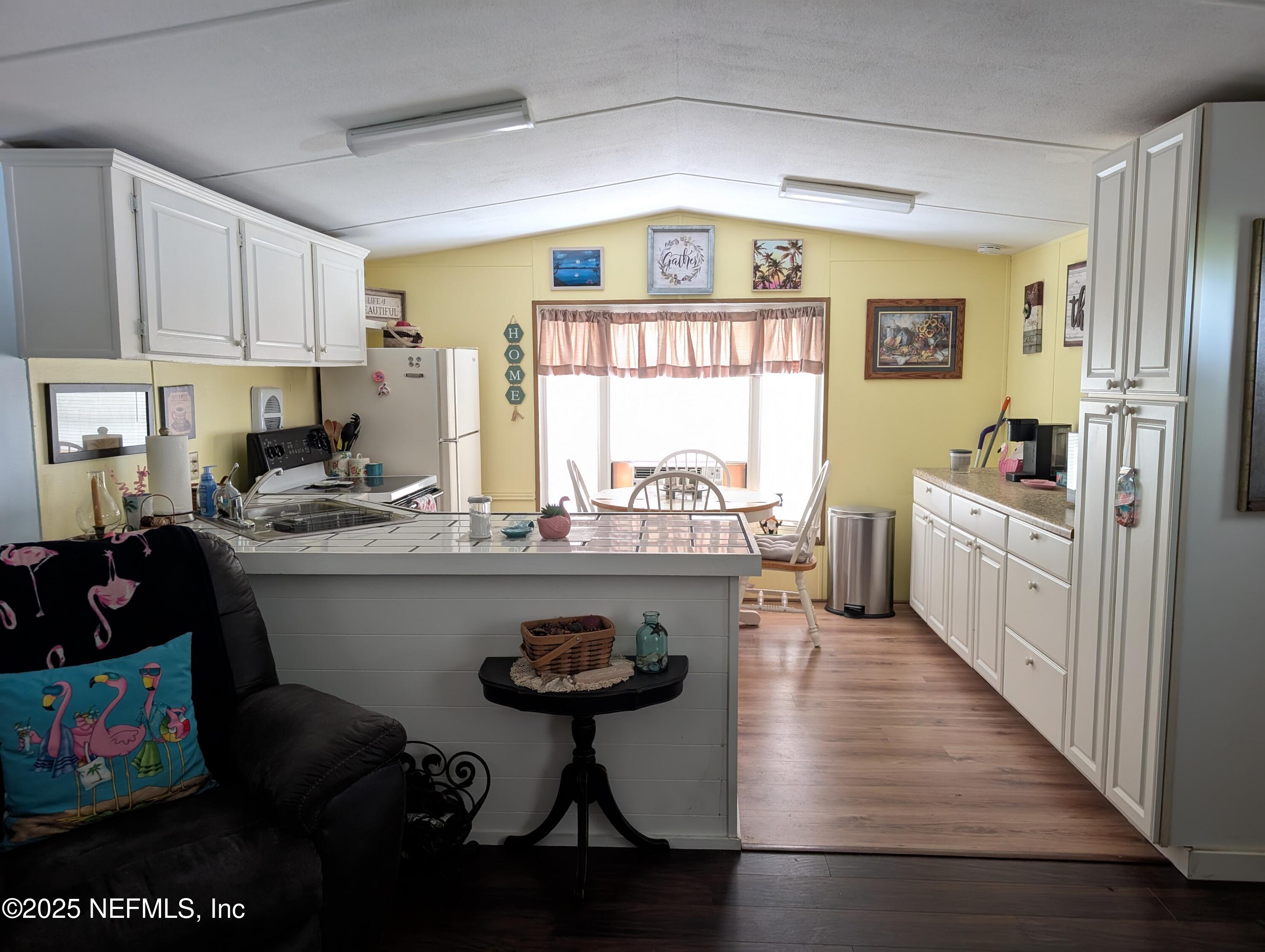 114 Ash Street Interlachen, FL 32148 - Photo 7 of 22 a kitchen with sink a stove and cabinets