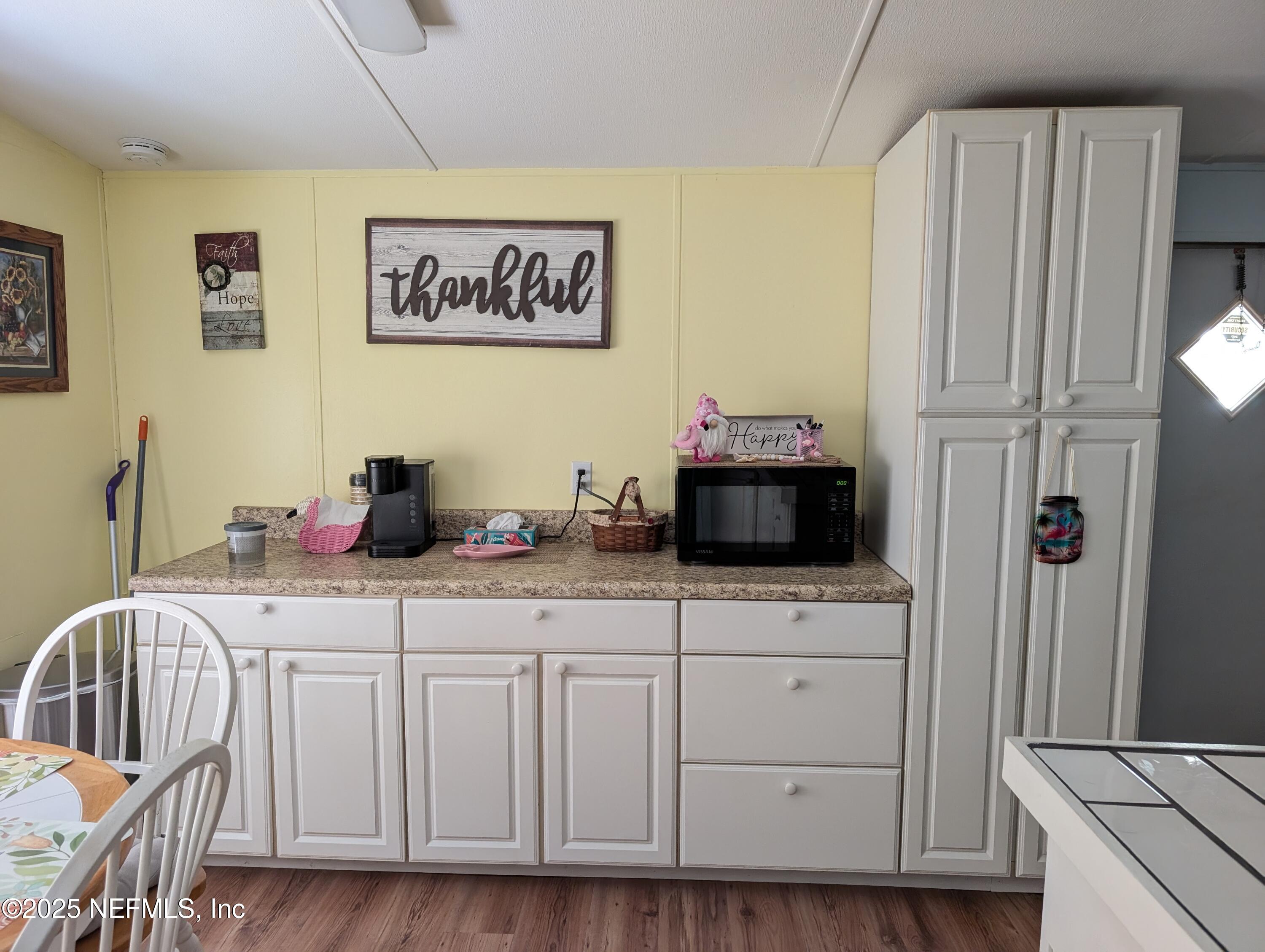 114 Ash Street Interlachen, FL 32148 - Photo 8 of 22 a kitchen with a sink cabinets and wooden floor