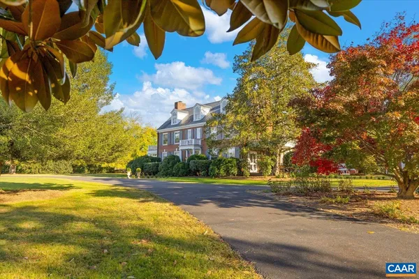 a dining room with furniture a chandelier and wooden floor