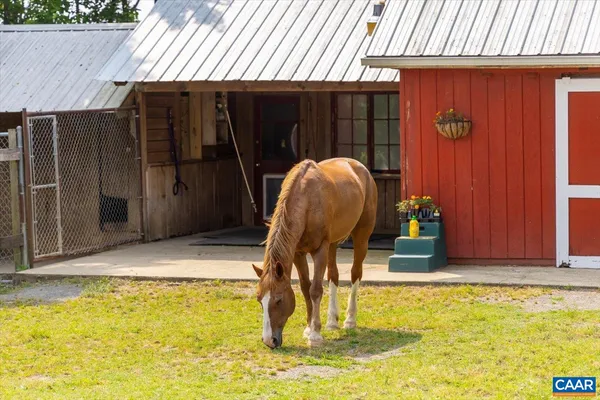 a dining room with furniture a chandelier and wooden floor