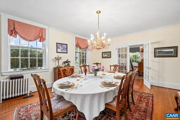 a bedroom with a bed mirror and a window