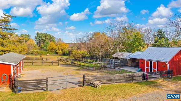 a view of swimming pool with seating area and trees in the background