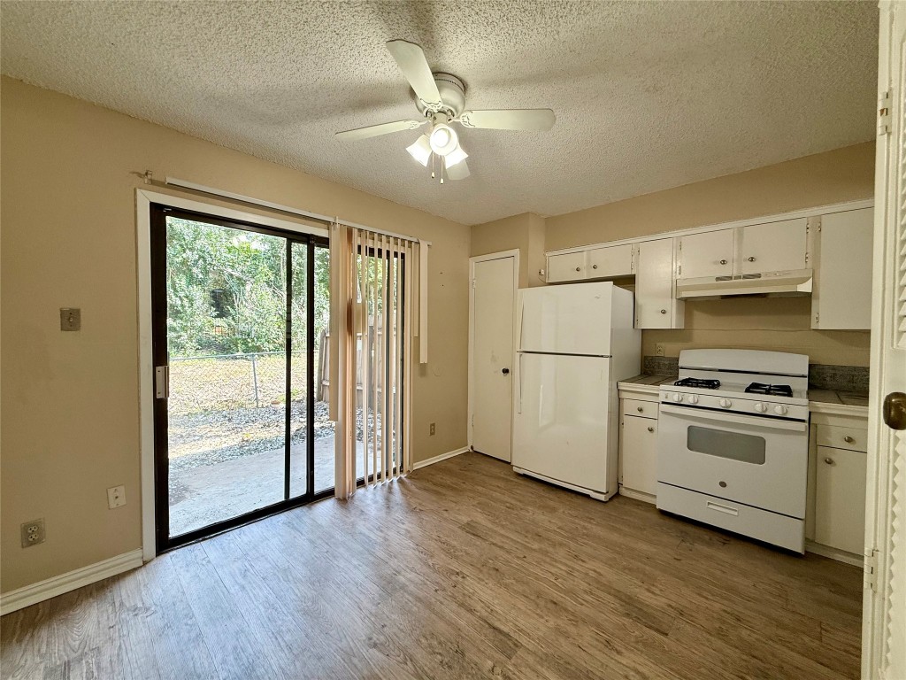 3448 Willowrun Drive, Unit C Austin, TX 78704 - Photo 2 of 9 a kitchen with appliances cabinets a sink and a large window
