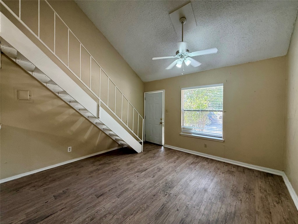 3448 Willowrun Drive, Unit C Austin, TX 78704 - Photo 4 of 9 an empty room with wooden floor fan and windows