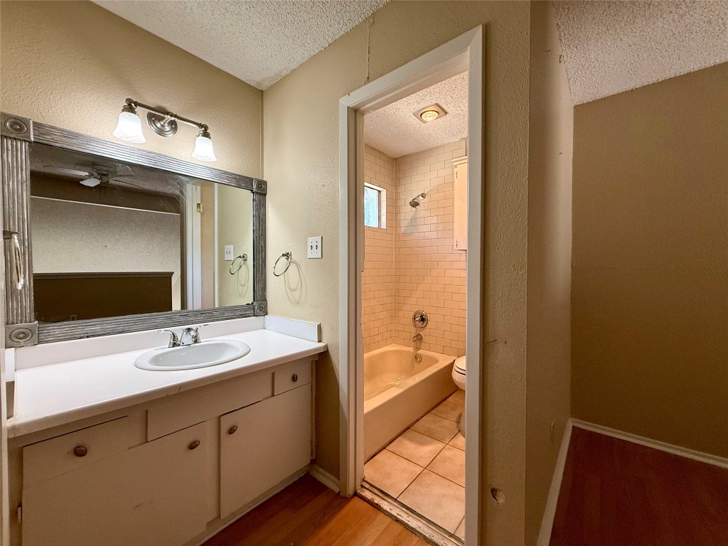 3448 Willowrun Drive, Unit C Austin, TX 78704 - Photo 7 of 9 a spacious bathroom with a double vanity sink and a mirror