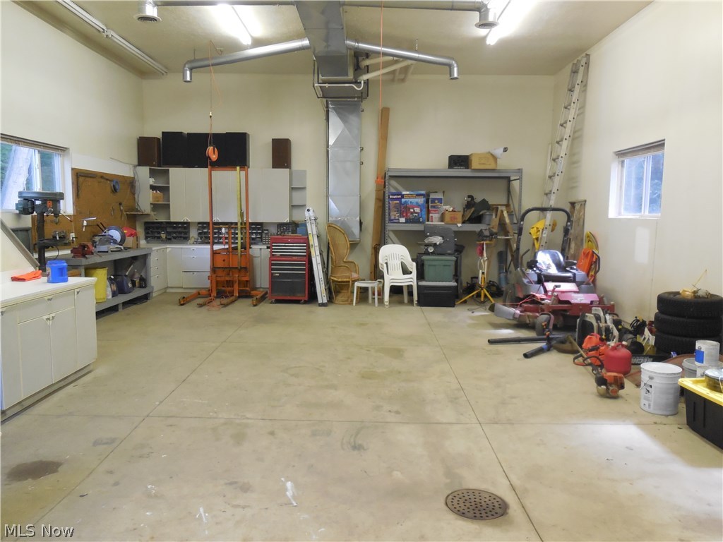 7071 Liberty Road Solon, OH 44139 - Photo 4 of 25 HUGE BARN WITH 12 FT DOOR, AIR CONDITIONING, HEAT, SEPARATE WELL WATER AND HALF BATH.CABINETS CAN BE REMOVED FOR EVEN MORE ROOM. PERFECT YEAR ROUND PLACE TO KEEP YOUR RV, MOTORCYCLES AND CARS. THE WELL IS JUST FOR WATERING AND CAR WASHING. THE HOUSE HAS CITY WATER AND SEWER.