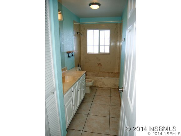 1719 South Riverside Drive Edgewater, FL 32132 - Photo 20 of 24 a bathroom with a tub shower and a sink
