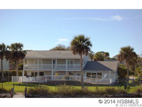 1719 South Riverside Drive Edgewater, FL 32132 - Photo 22 of 24 a front view of a house with a yard