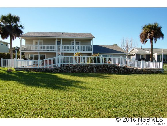 1719 South Riverside Drive Edgewater, FL 32132 - Photo 5 of 24 a front view of a house with a yard table and chairs