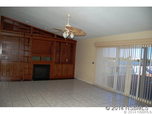 1719 South Riverside Drive Edgewater, FL 32132 - Photo 8 of 24 a view of an empty room and kitchen with wooden floor