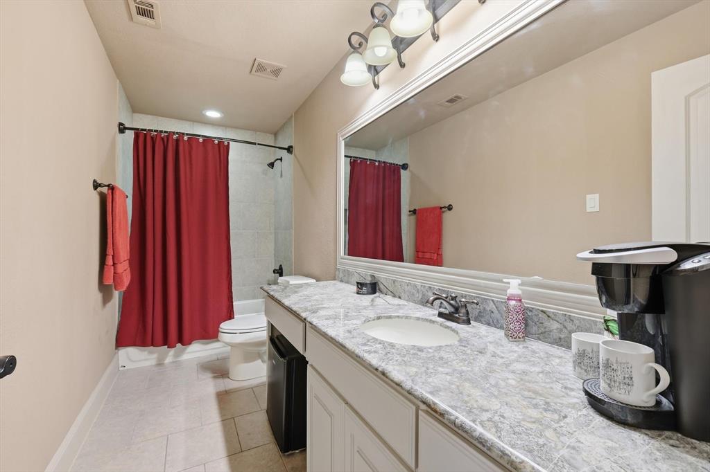 406 Spurgin Road Lucas, TX 75002 - Photo 26 of 39 Bathroom with vanity, shower / bath combination with curtain, and light tile patterned floors
