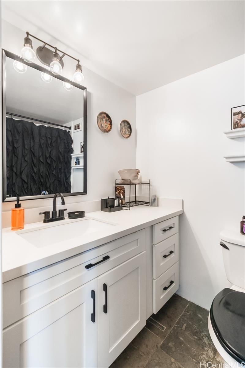 1069 Spencer Street, Unit 402 Honolulu, HI 96822 - Photo 10 of 15 a bathroom with a sink and a mirror