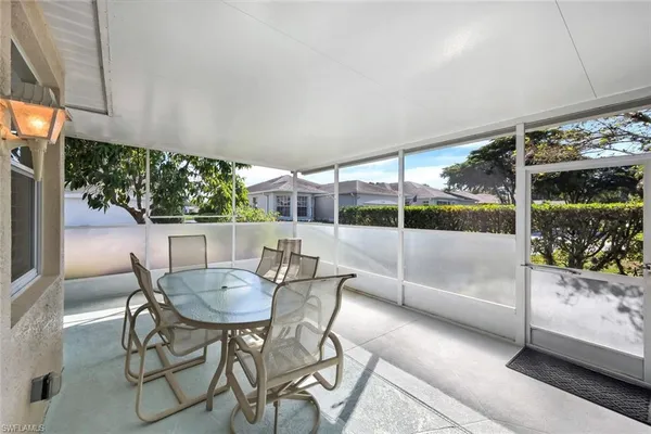 a view of a patio with a table and chairs