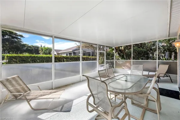 a patio with yard glass top table and chairs