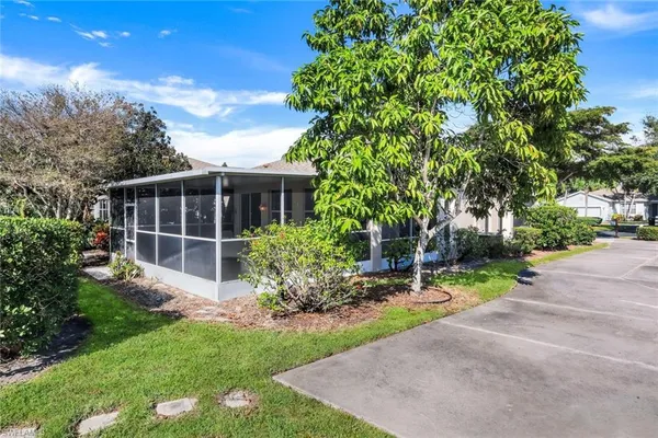 a view of an house with backyard space and garden