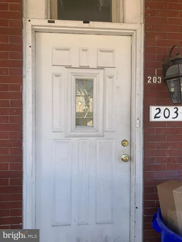 a living room with furniture and a dining table with wooden floor
