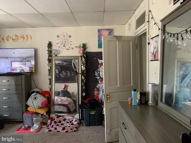 a bathroom with a sink mirror and toilet