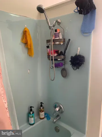 a view of a storage and utility room with wooden floor