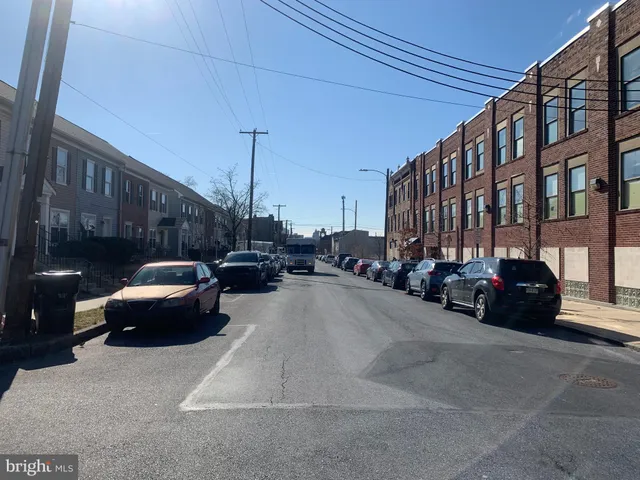 a view of a cars park in front of a building