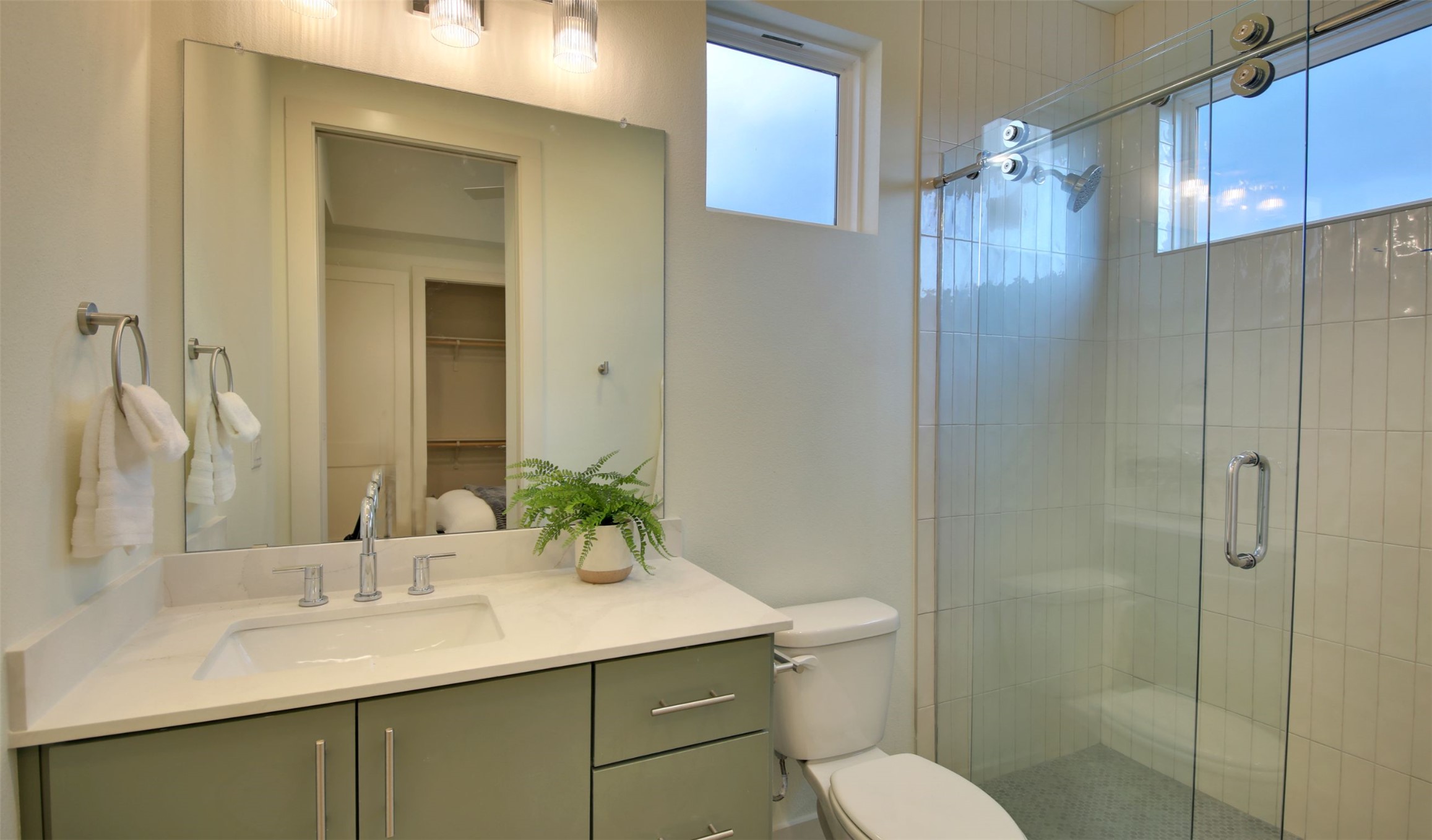 6802 Montana Street, Unit 2 Austin, TX 78741 - Photo 12 of 13 A well-appointed bathroom with a spacious vanity and sleek glass-enclosed shower.