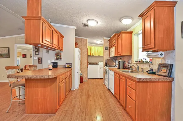 an aerial view of residential house with outdoor space and trees all around