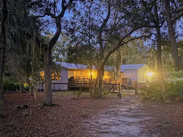 a large kitchen with stainless steel appliances granite countertop a lot of counter space and wooden floors