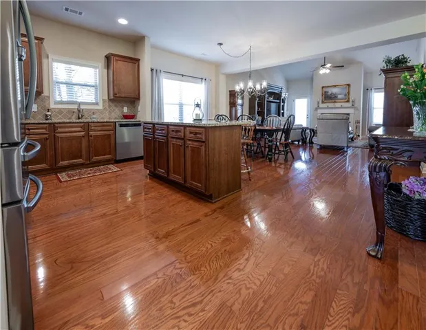a large kitchen with lots of counter space and stainless steel appliances