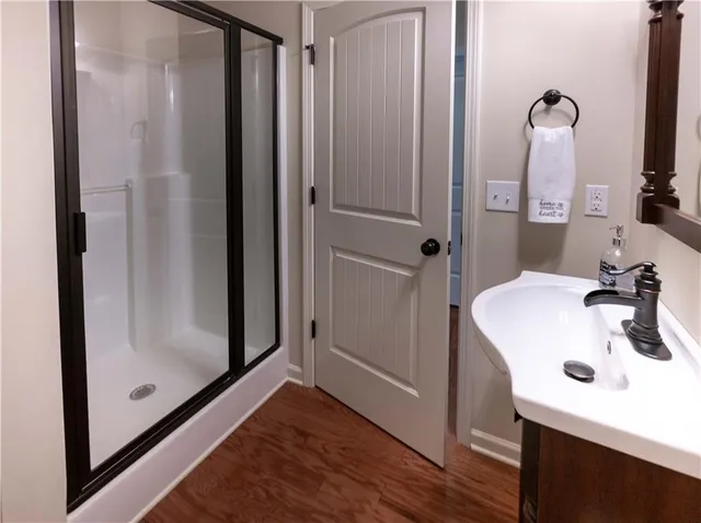 a bathroom with a sink a mirror and shower
