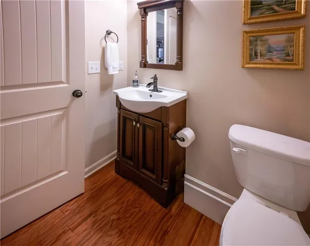 a bathroom with a sink a toilet and mirror