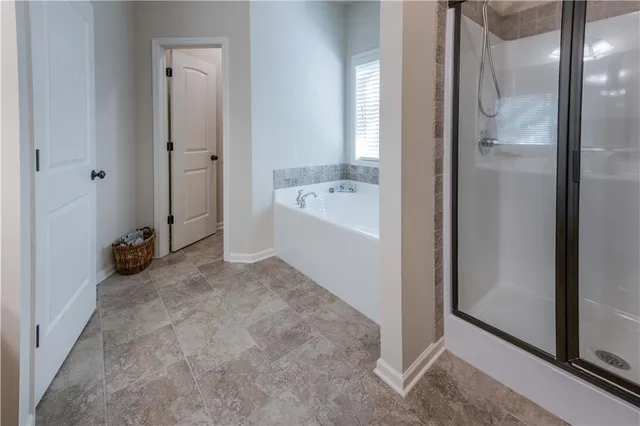 a view of a bathroom with a bathtub and shower