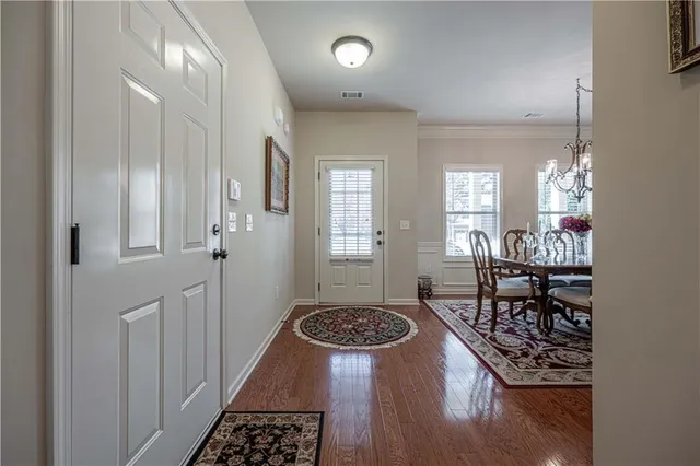 a very nice looking dining room with a rug stove and wooden floor